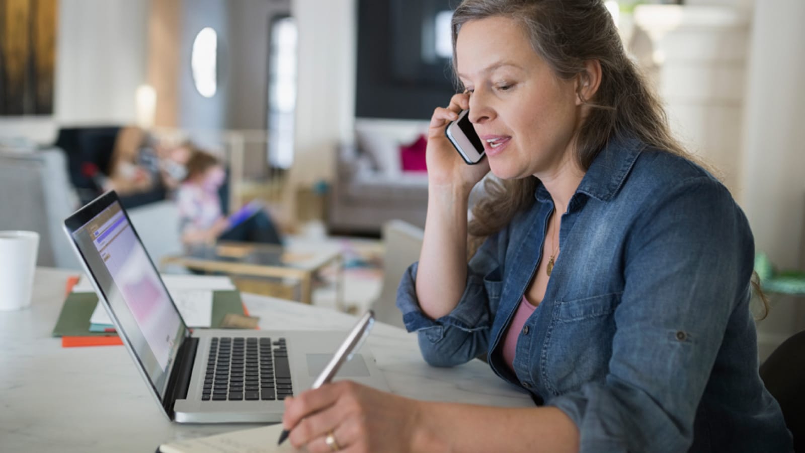telecommute-large Woman talking on the phone at home