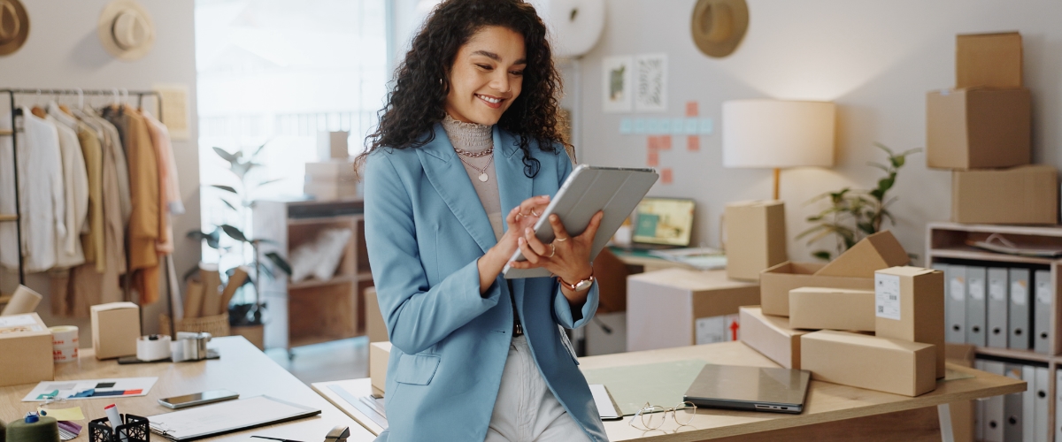 May 4 blog Young female business owner reading iPad.